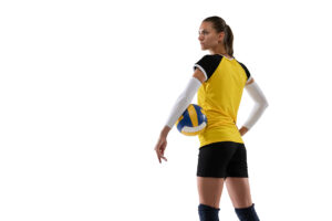 Volleyball player in yellow jersey holding ball